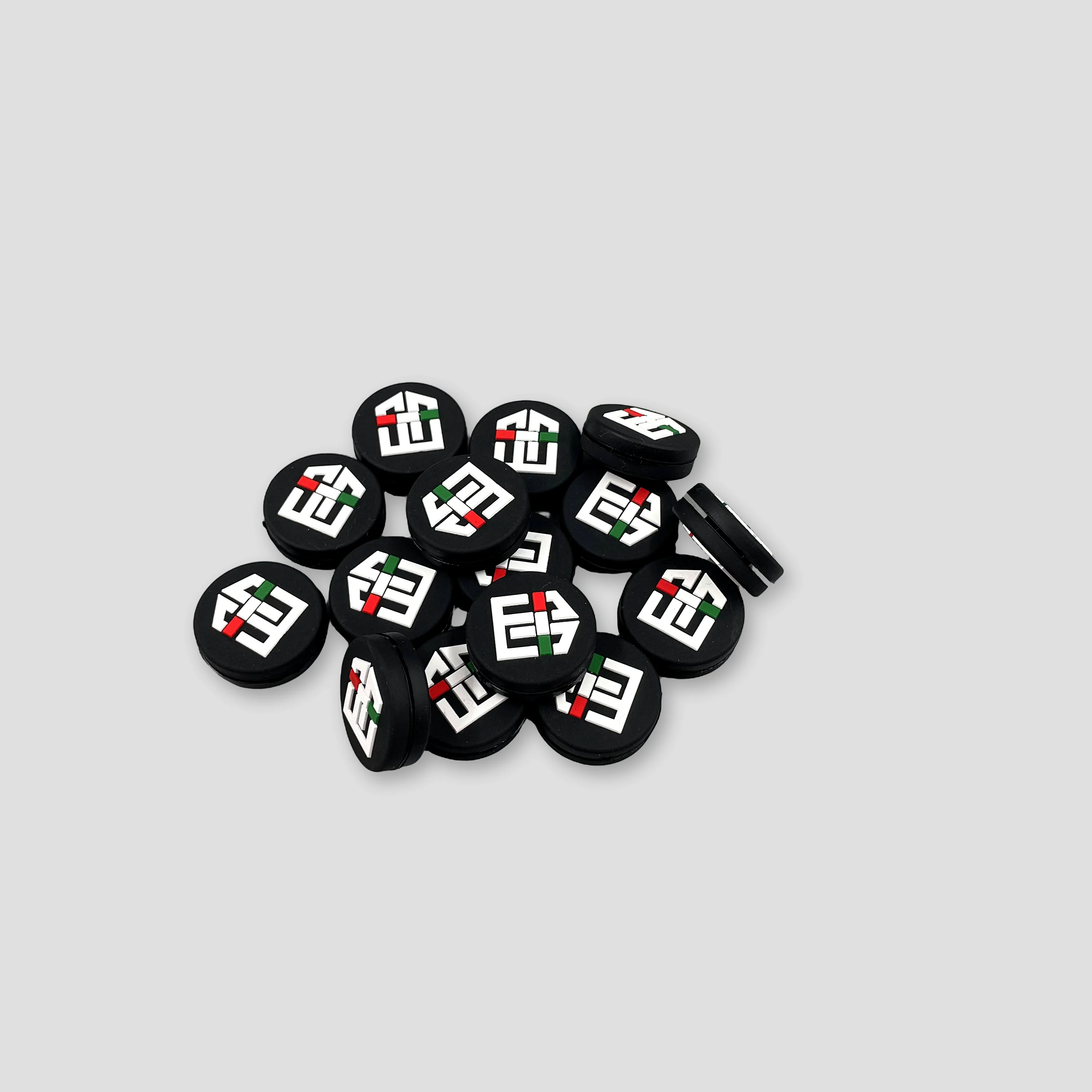 A finished black custom dampener order with raised white, red, and green molded details