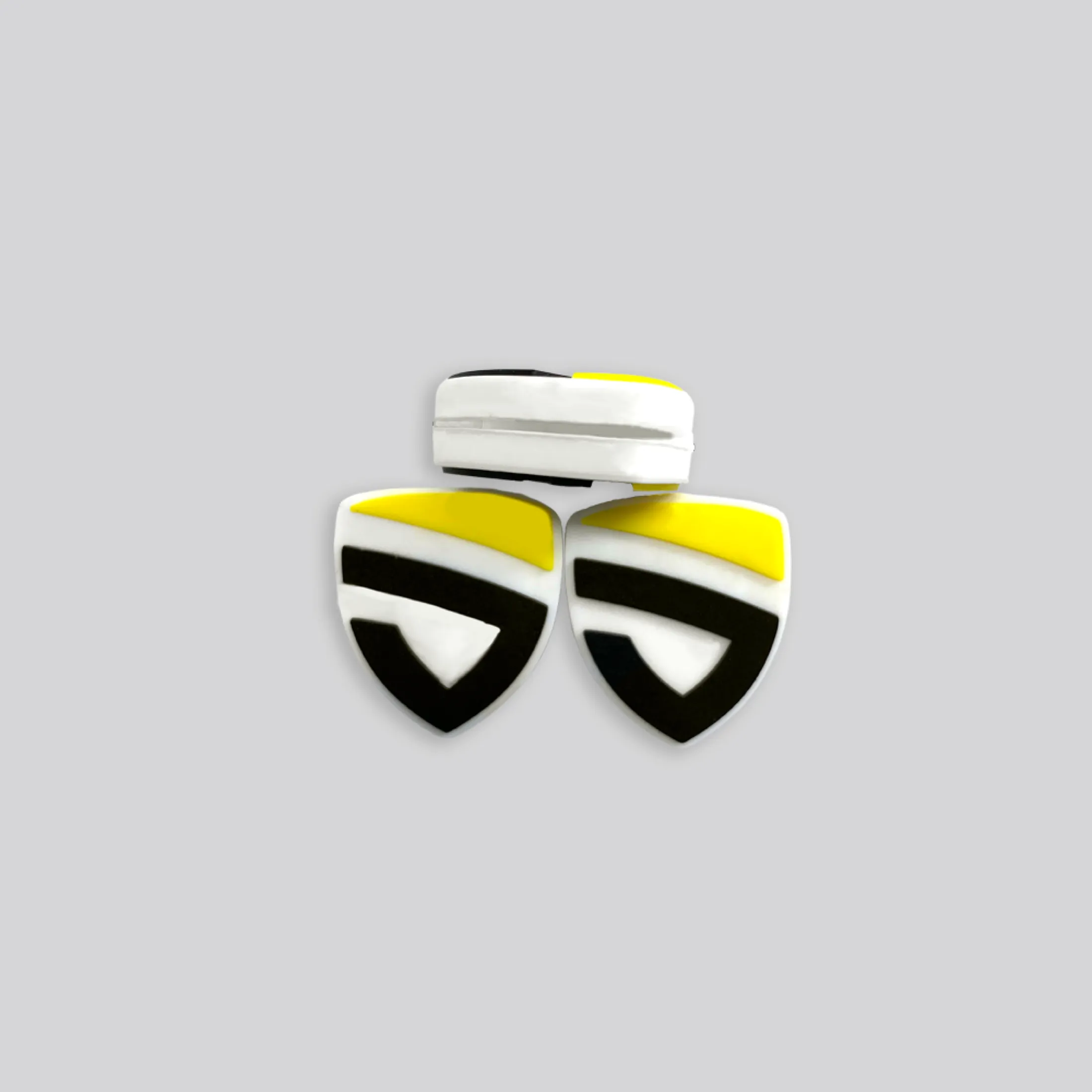 Shield-shaped custom dampeners in black, white, and yellow team colors