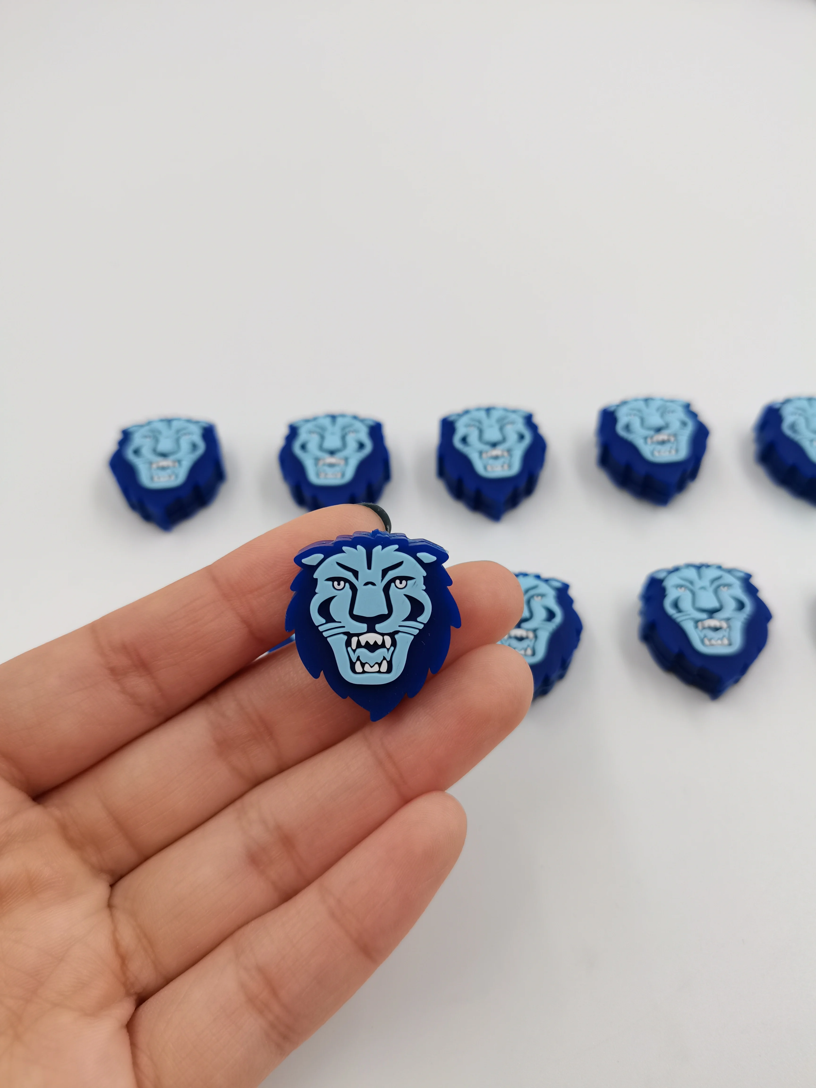 Dimensional blue lion-shaped custom tennis dampeners