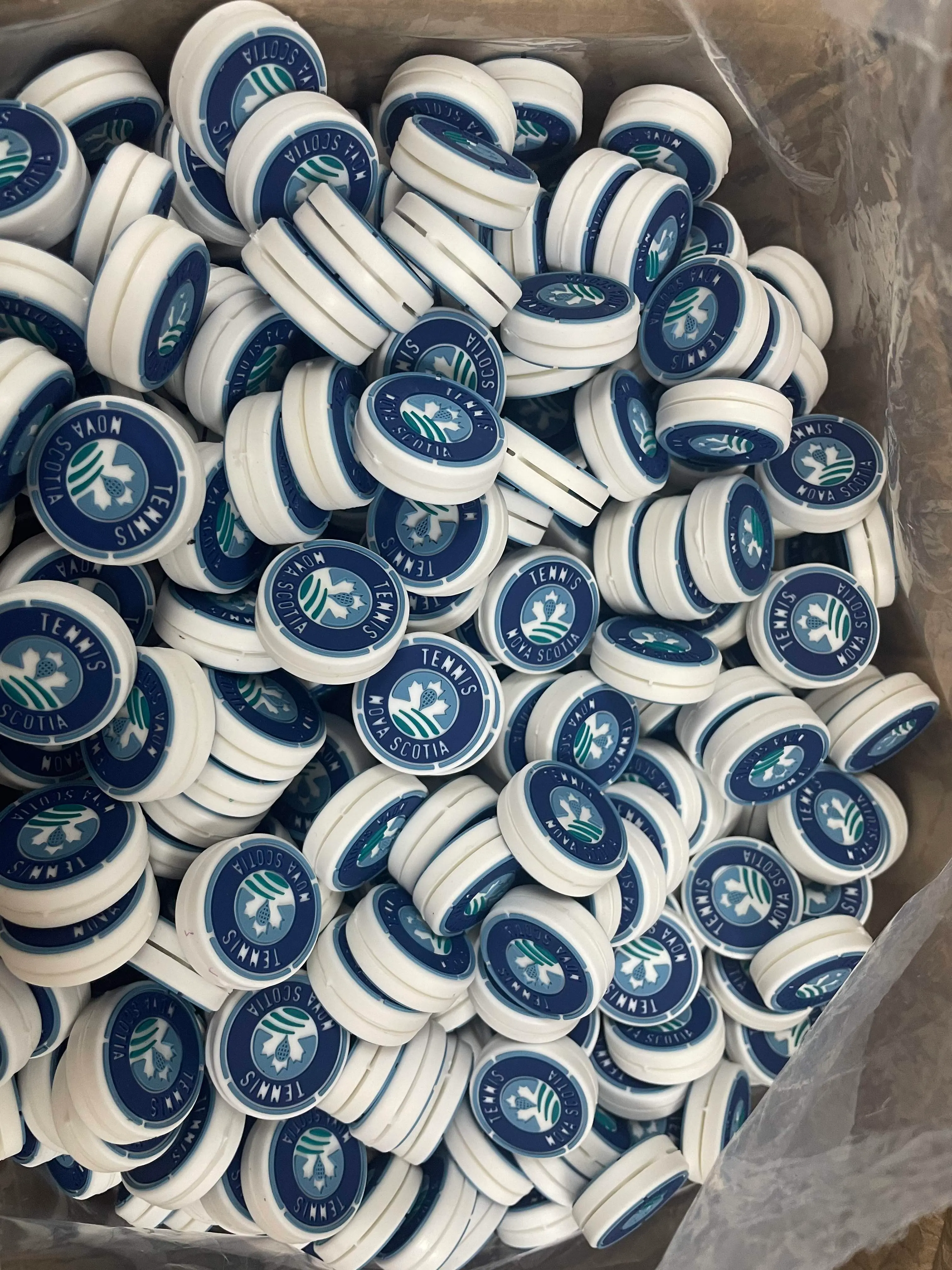 A dense finished order of blue and white Tennis Nova Scotia custom dampeners