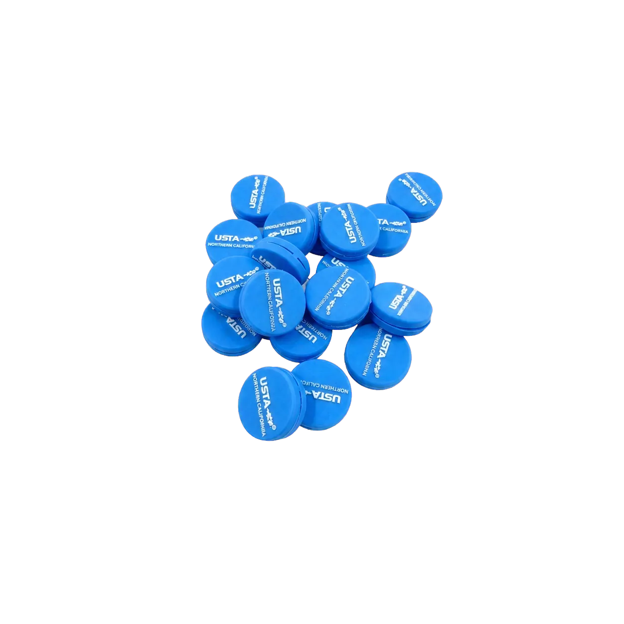 A production group of blue USTA Northern California custom tennis dampeners on a gray surface